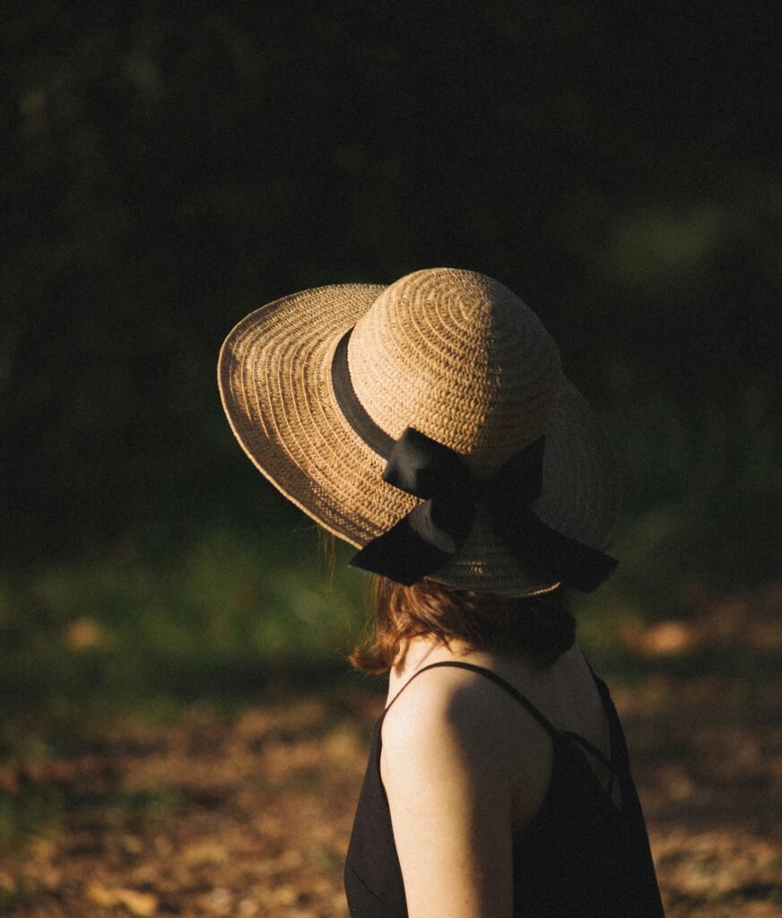 woman in black tank top wearing brown sun hat